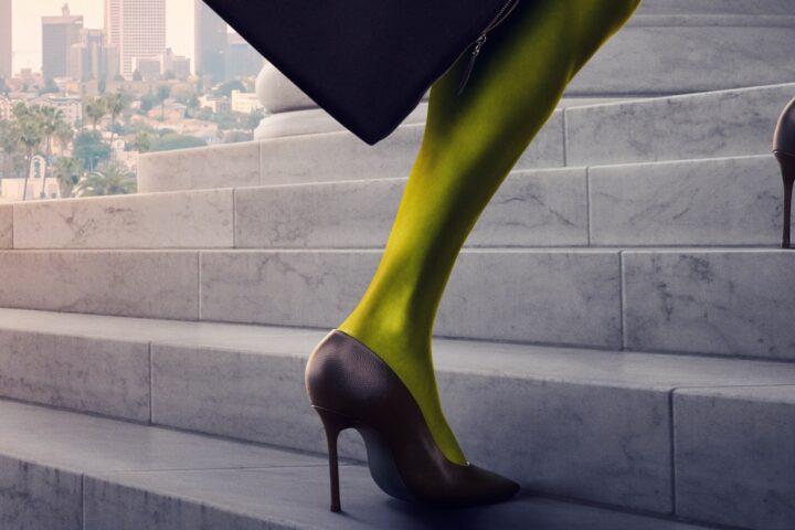 An image of a green leg in a high heel ascending the steps of a courthouse. Downtown LA is in the background.