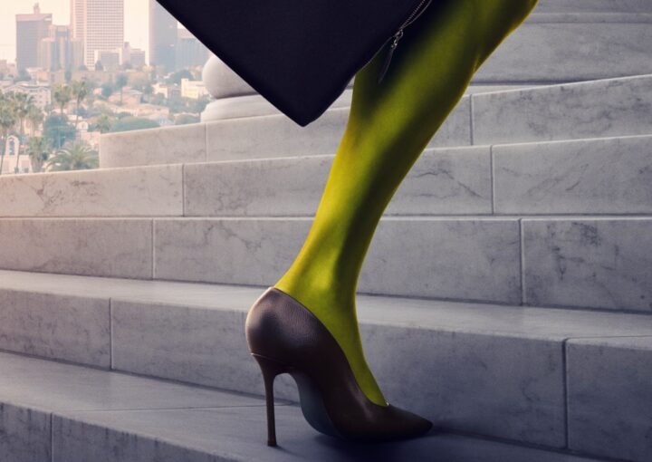An image of a green leg in a high heel ascending the steps of a courthouse. Downtown LA is in the background.