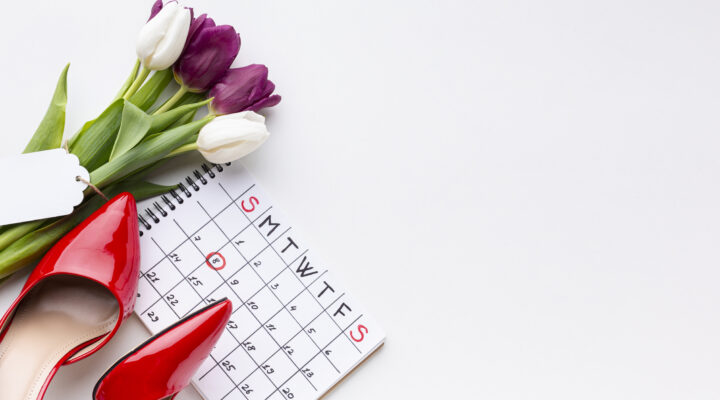 Photo of a red high heels, tulips and a calendar with the date 8 circled in red pencil.